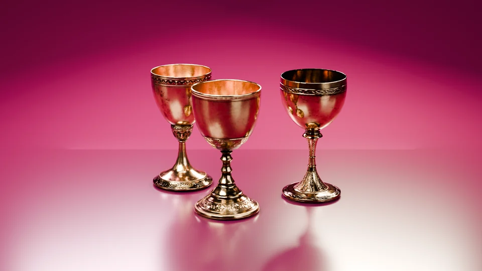 3D render of three engraved brass goblets on a glossy magenta studio floor.